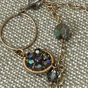 Women's Gold-tone chain, crystal necklace with various beads and rings.